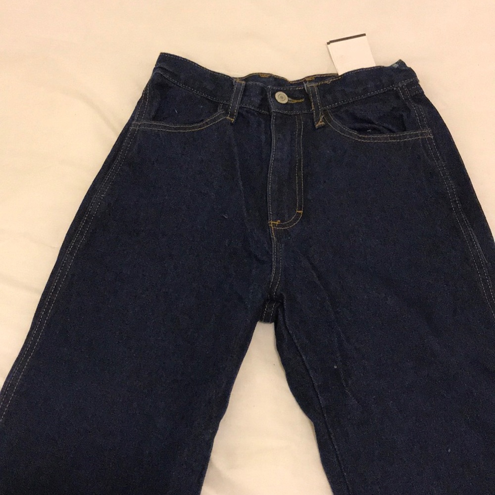 Dark wash denim with raw hem